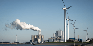 © Shutterstock/Sander van der Werf | Wind turbines and a coal power plant in Eemshaven port in the Netherlands.